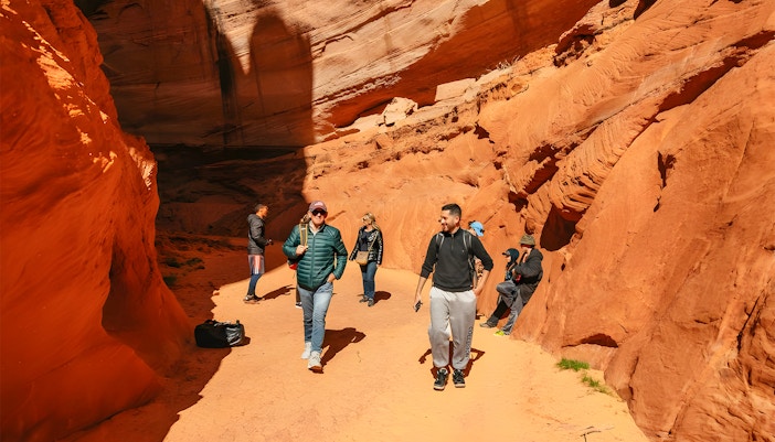 Guests exploring the red rock formations of Antelope Canyon.
