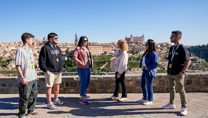 A tour guide giving information to tourist during Toledo Half Day Guided Tour from Madrid