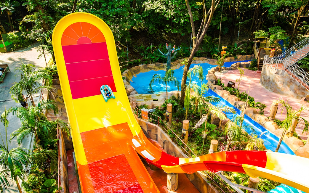Water slide at Sunway Lagoon amusement park surrounded by tropical greenery.
