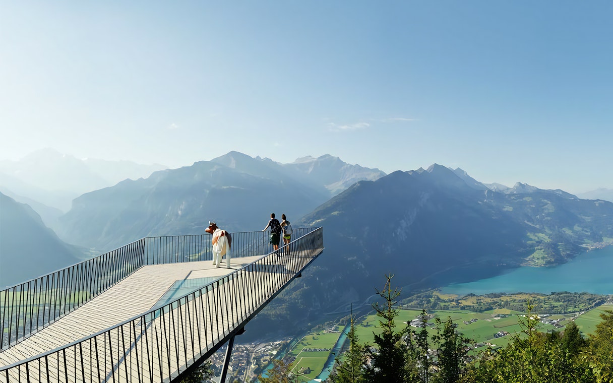Visitors on a viewing platform overlooking Lake Lucerne and mountains, Mount Rigi, Switzerland.