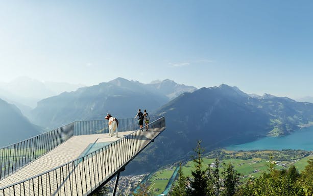 Visitors on a viewing platform overlooking Lake Lucerne and mountains, Mount Rigi, Switzerland.