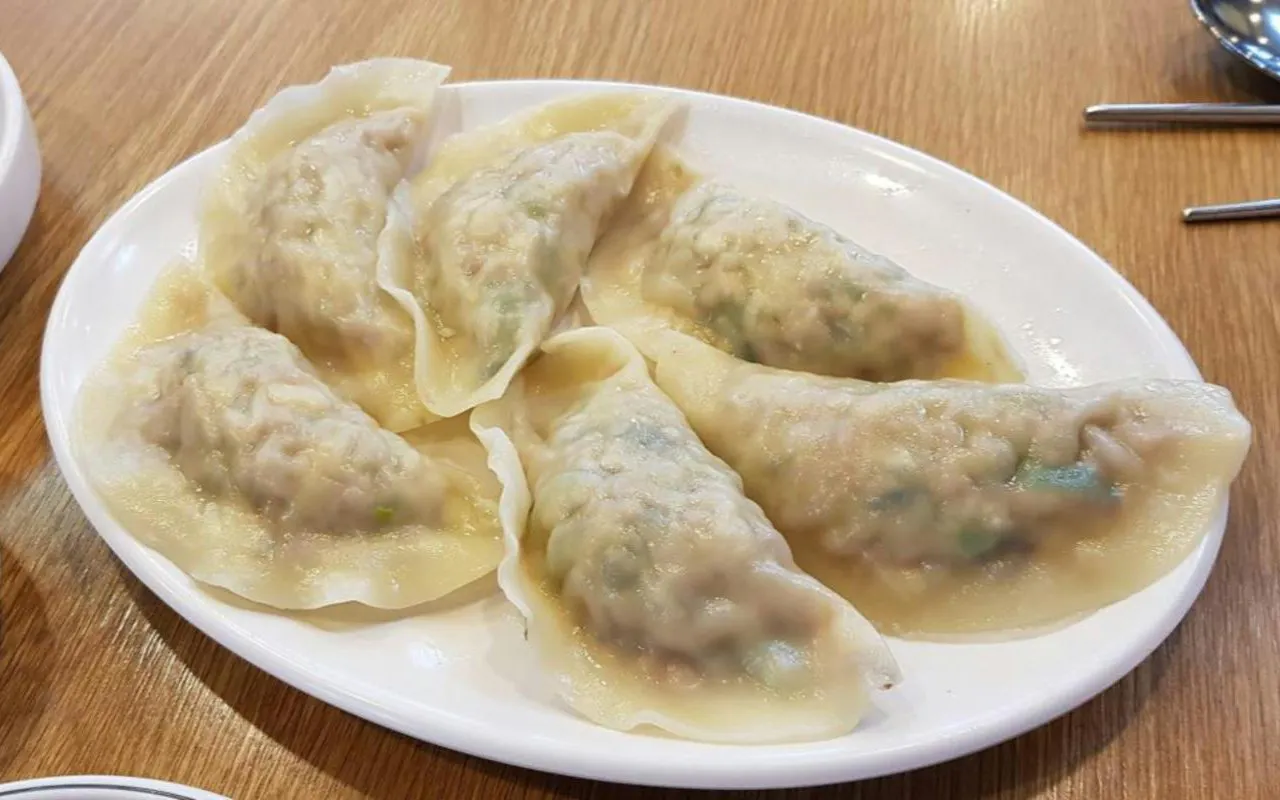Plate of Korean dumplings served on a wooden table during DMZ tour experience.
