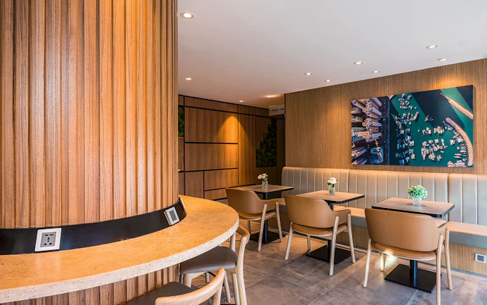 Plaza Premium Lounge seating area with wooden decor and wall art.