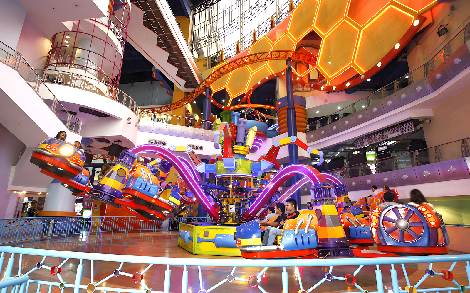 Berjaya Times Square Theme Park indoor ride with colorful cars and neon lights.