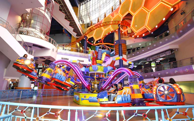 Berjaya Times Square Theme Park indoor ride with colorful cars and neon lights.