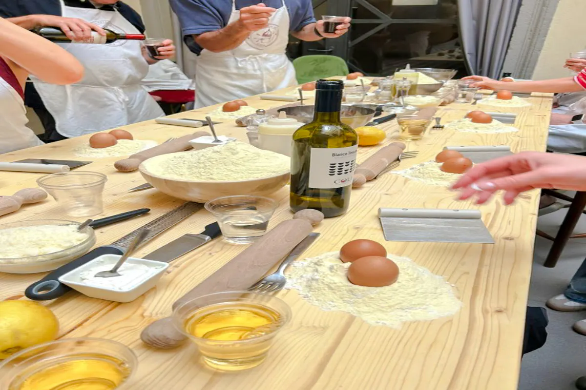 Participants preparing ingredients for pasta and dessert making class in Florence.