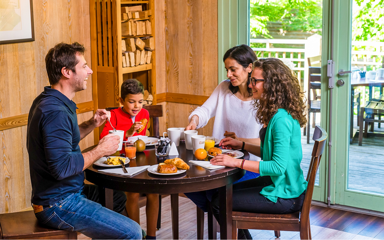Visitors enjoying a meal at Parc Asterix restaurant, France, surrounded by themed decor.