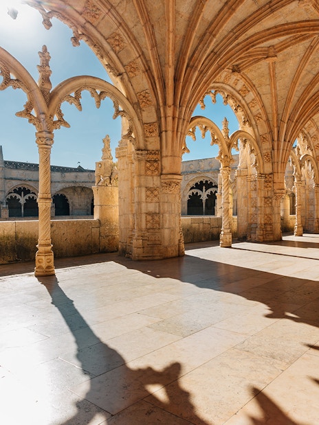 Gothic arches and stone columns inside Jerónimos Monastery, Lisbon.