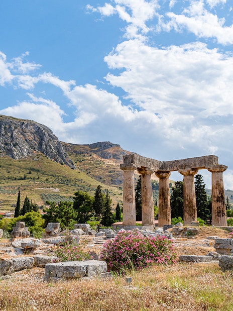 Temple of Apollo ruins at Ancient Corinth with Acrocorinth castle in the background.