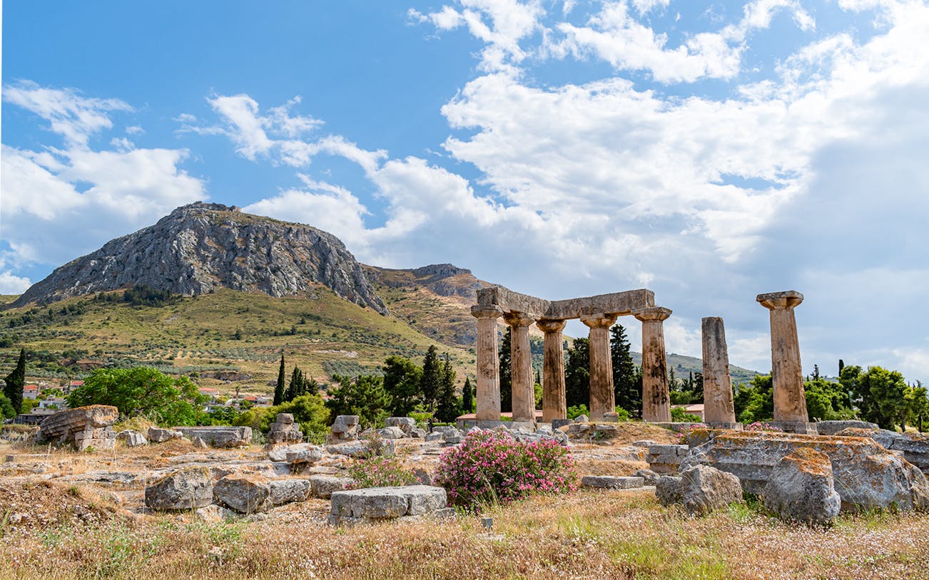 Temple of Apollo ruins at Ancient Corinth with Acrocorinth castle in the background.