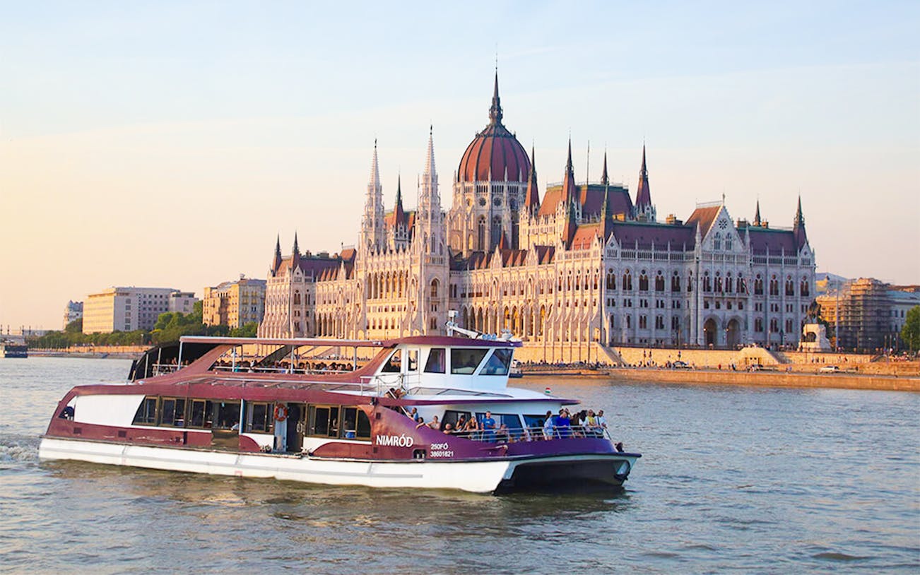 Cruise boat on the Danube River with Budapest Parliament in the background during Margaret Island Loop tour.