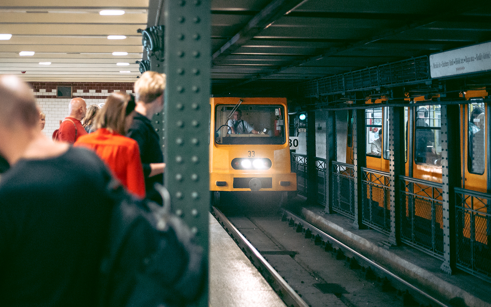 Historic Budapest metro station with vintage train on old subway line.