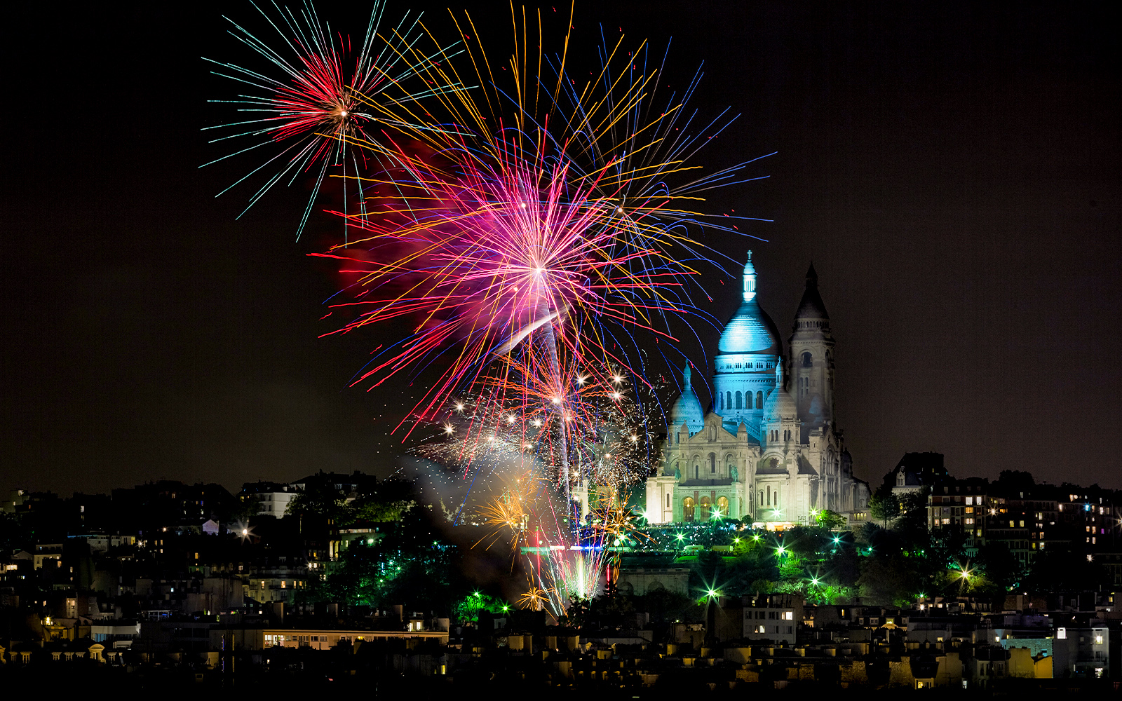 Sacre-Coeur Basilica with fireworks in Paris, France.