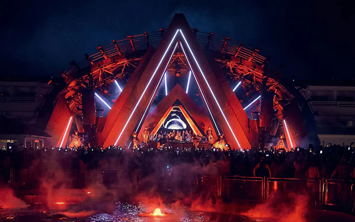 Ants Ushuaïa Ibiza stage with crowd and vibrant lights at night.