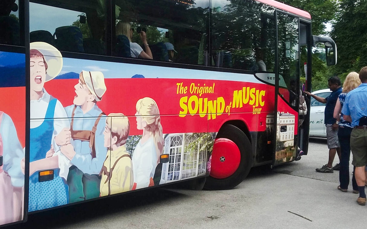Sound of Music tour bus with passengers boarding in Salzburg, Austria.
