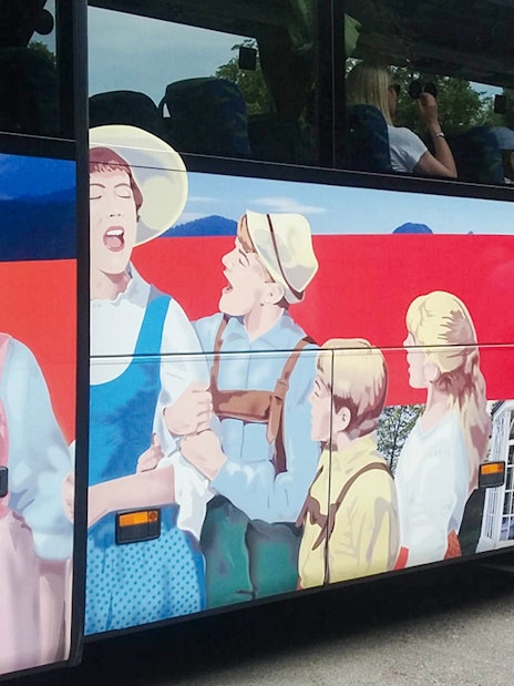 Sound of Music tour bus with passengers boarding in Salzburg, Austria.