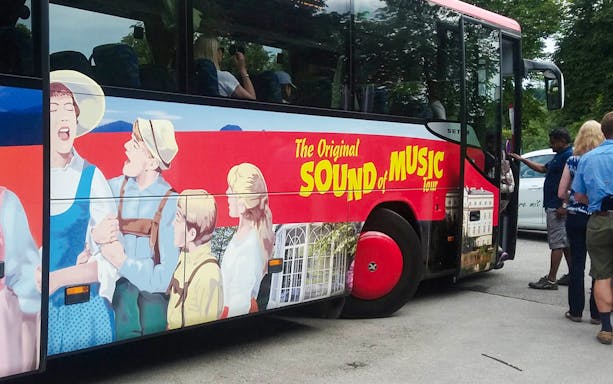 Sound of Music tour bus with passengers boarding in Salzburg, Austria.