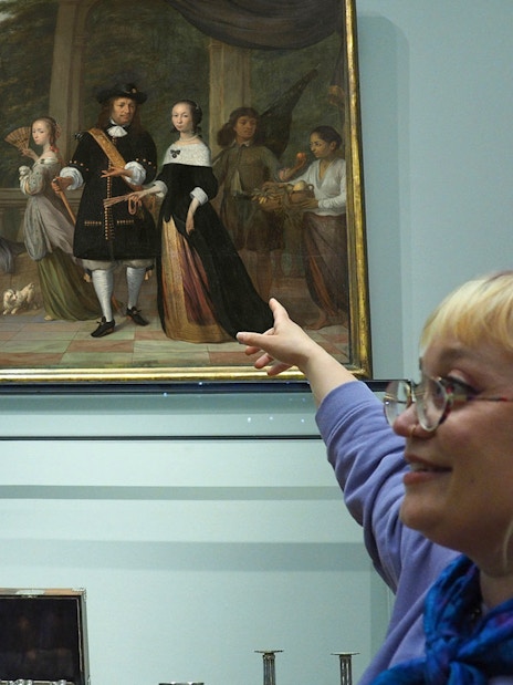 Guide pointing at a painting during Rijksmuseum private tour.