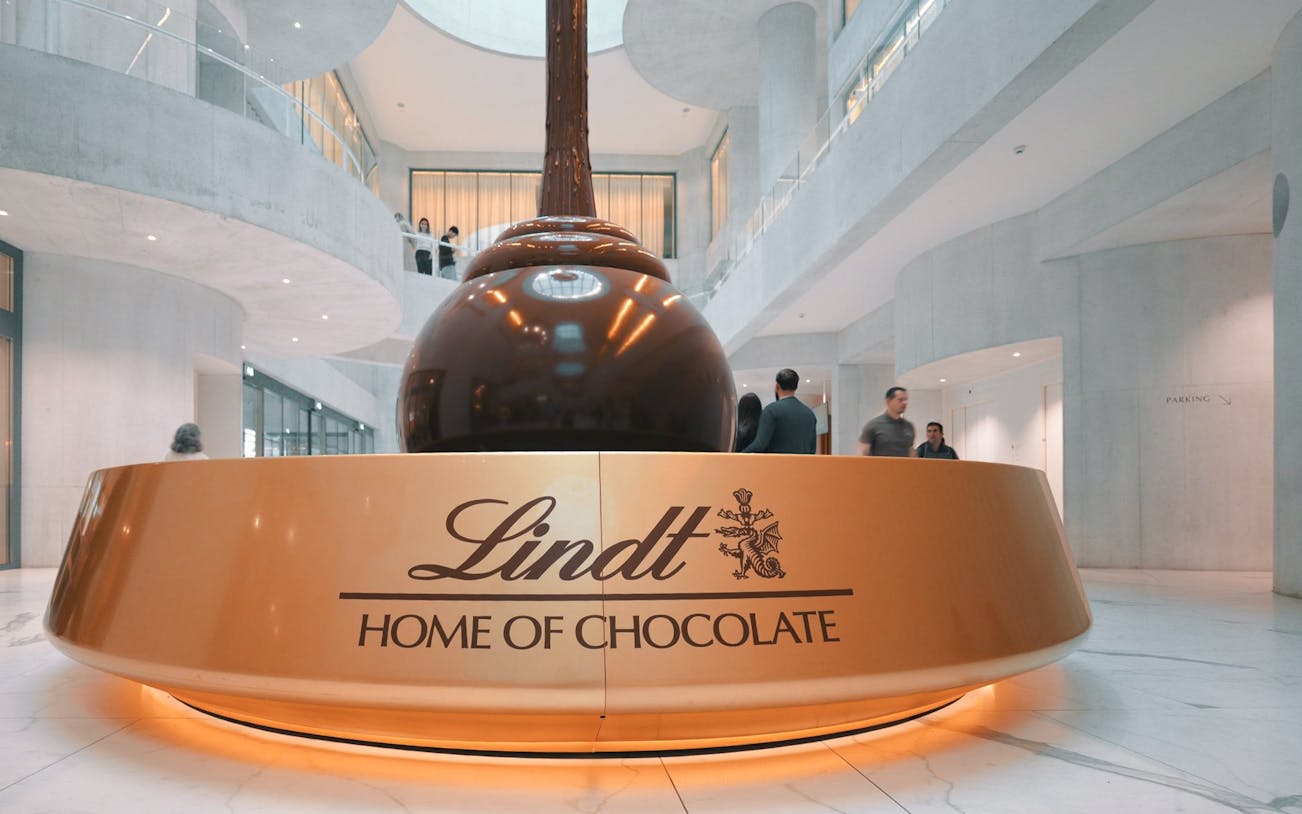 Lindt Chocolate Museum interior with large chocolate fountain centerpiece.