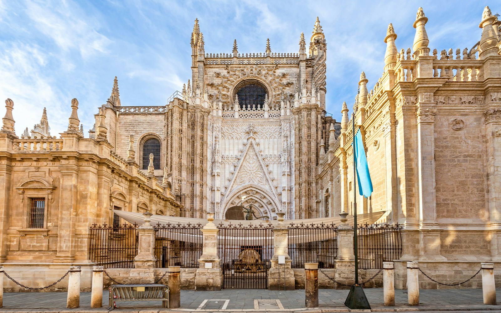 Seville Cathedral exterior with Giralda tower, showcasing Gothic architecture in Seville, Spain.