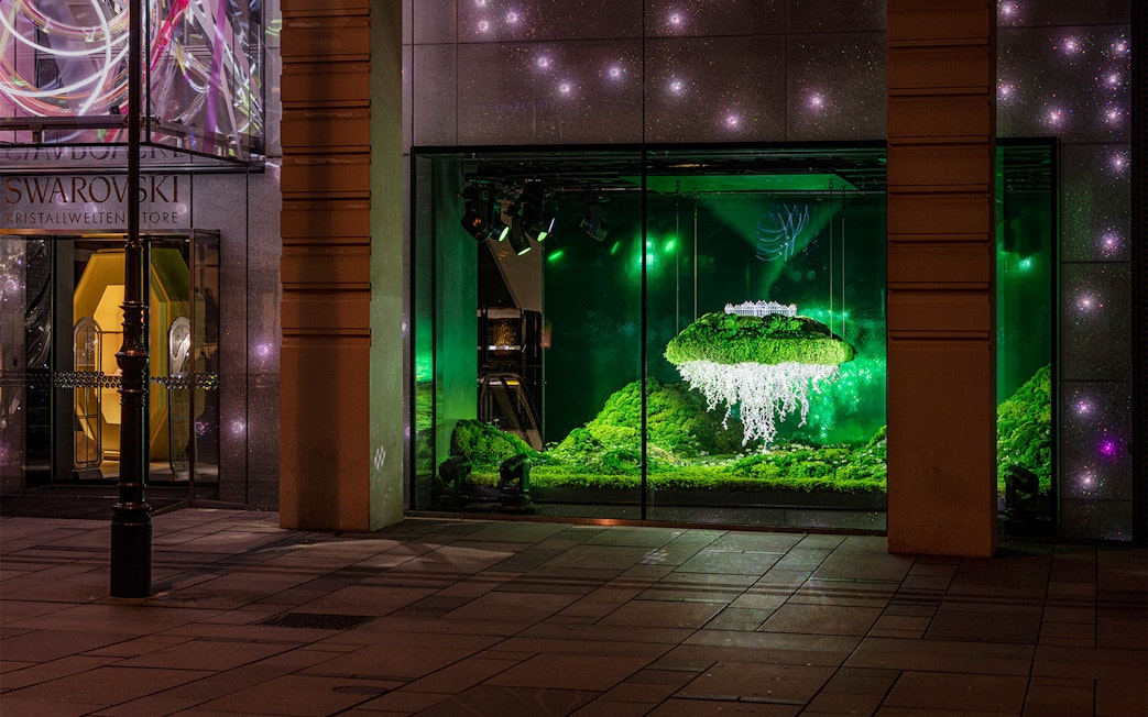 Swarovski House Vienna display with illuminated crystal installation and greenery.