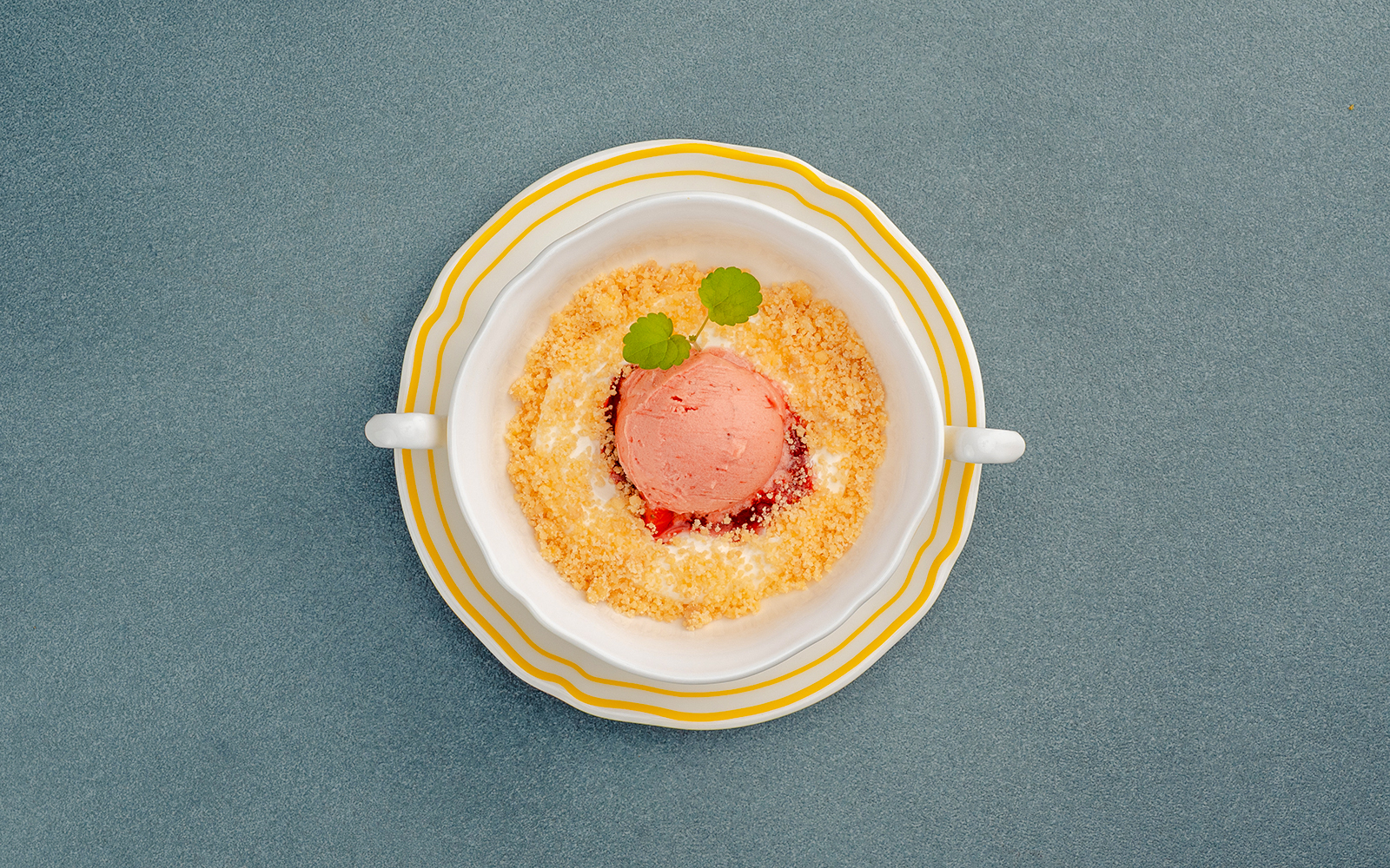 Cheesecake mousse with crumble and garnish in a dish, Berlin.