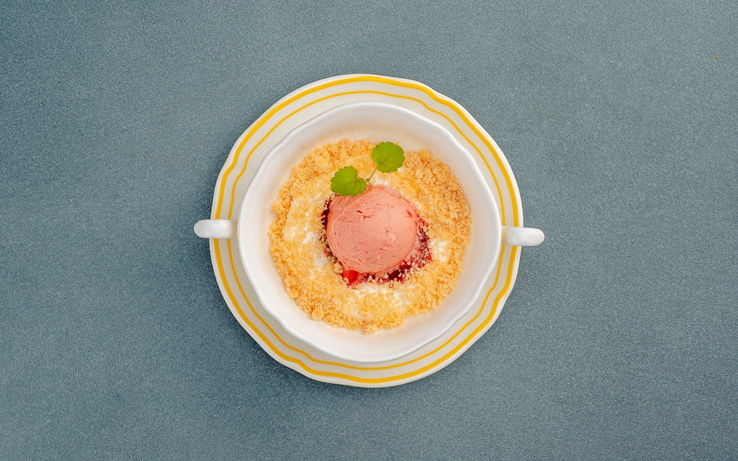 Cheesecake mousse with crumble and garnish in a dish, Berlin.