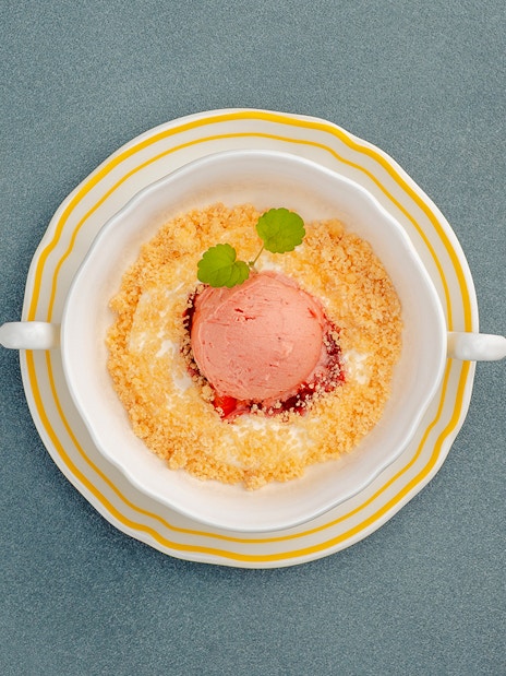 Cheesecake mousse with crumble and garnish in a dish, Berlin.