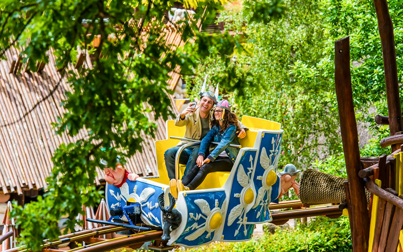 Visitors enjoying a roller coaster ride at Parc Asterix, France.