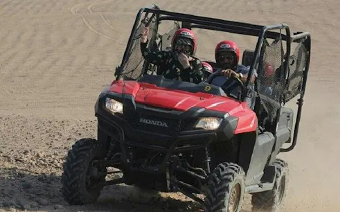Family riding buggy on desert safari in Echo Valley, Sharm El Sheikh.