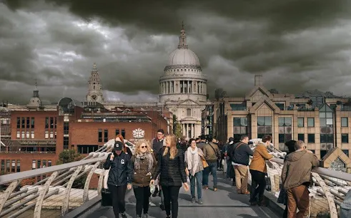 Walking tour on Millennium Bridge with view of St. Paul's Cathedral, London.