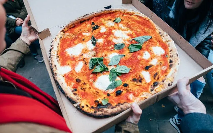 Pizza being shared during Edinburgh Cheese Crawl food tour.