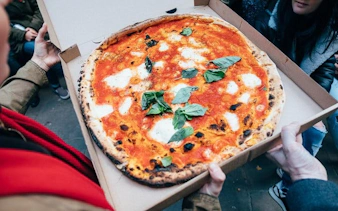 Pizza being shared during Edinburgh Cheese Crawl food tour.