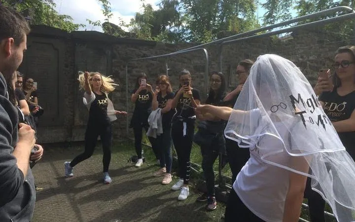 Group enjoying Harry Potter walking tour in Edinburgh with themed activities.