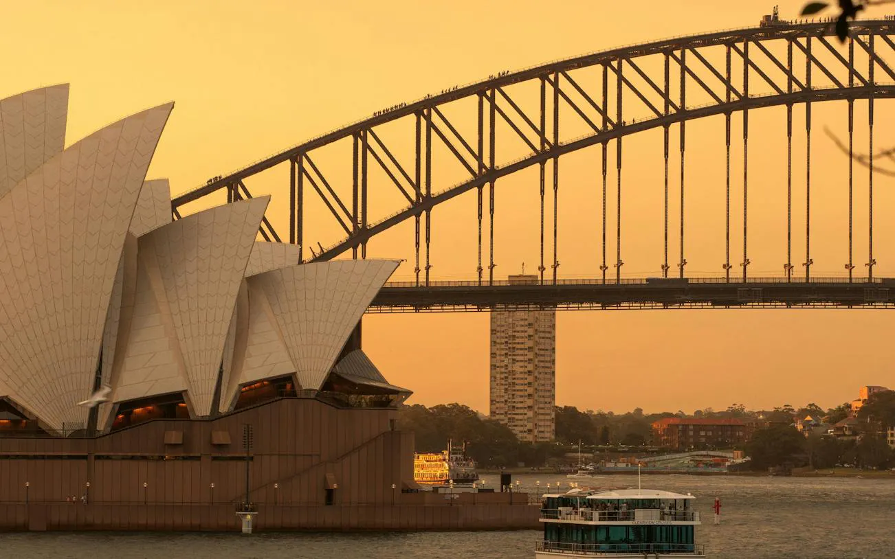 Sydney Opera House and Harbour Bridge at sunset, view from The Rocks, Sydney.