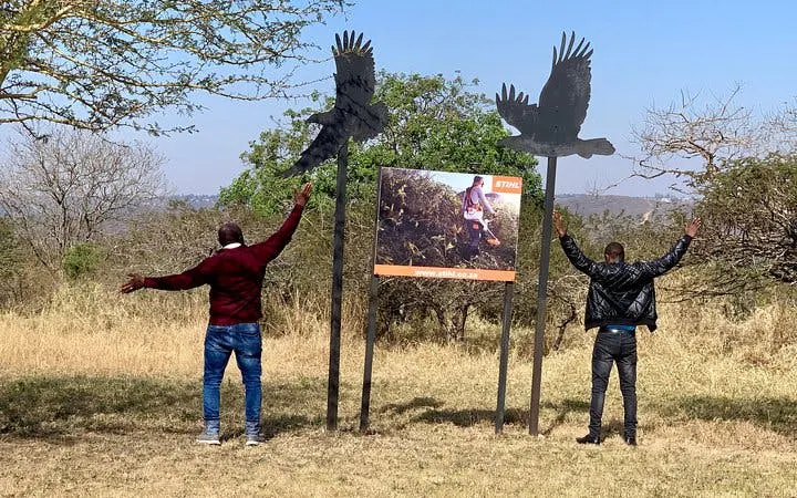 Two people with outstretched arms near bird sculptures at Natal Lion Park, Durban.