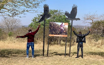 Two people with outstretched arms near bird sculptures at Natal Lion Park, Durban.