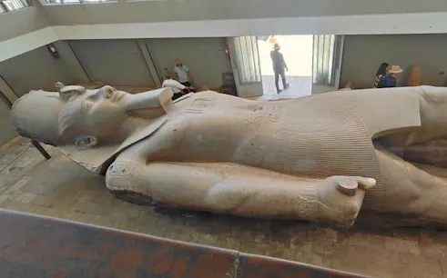 Colossal statue of Ramses II in Memphis, Egypt, viewed during a guided tour.