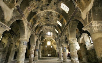 Ancient stone arches inside a historic Cappadocia church on a private tour.