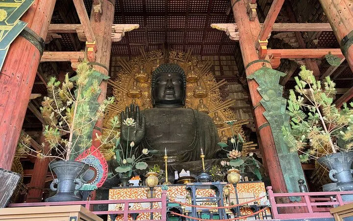 Great Buddha statue inside Todai-ji Temple, Nara, Japan, surrounded by ornate decorations.