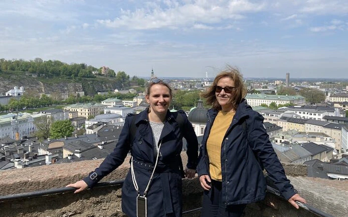 Two people enjoying a view of Salzburg from a high vantage point during a self-guided city exploration game.