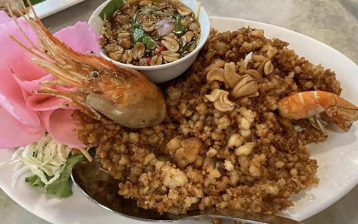 Thai dish with shrimp, crispy topping, and dipping sauce, part of Night Market Tour dining experience.