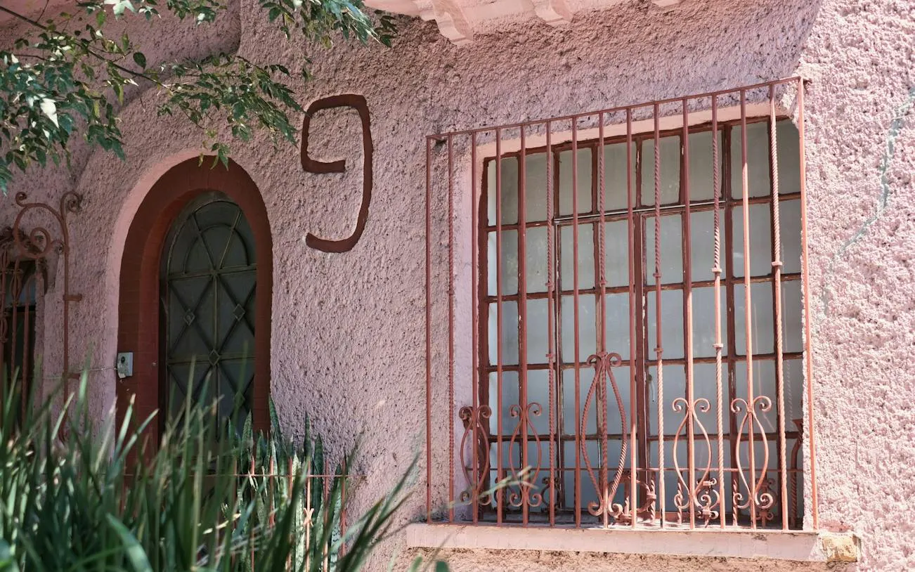 Facade of the Witches' House with arched door and barred window, Roma, Mexico City.