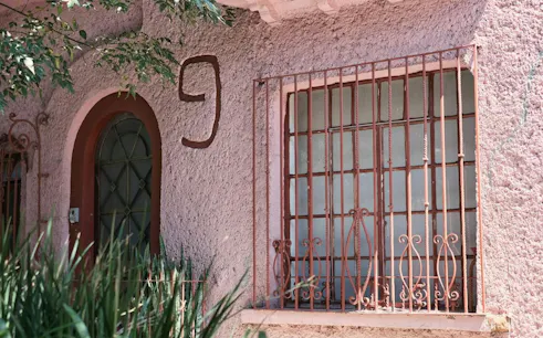 Facade of the Witches' House with arched door and barred window, Roma, Mexico City.