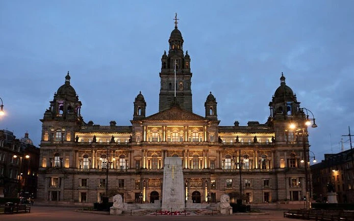 Glasgow City Chambers illuminated at dusk, part of Ghosts of Glasgow exploration game.