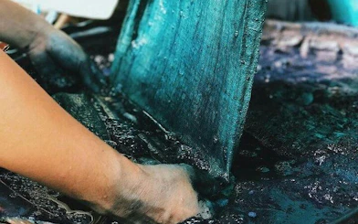 Hands dyeing fabric in indigo at a workshop in Ta Van Village, Sa Pa.