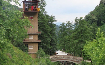 Tower and bridge surrounded by lush greenery in Sapanca, Turkey.