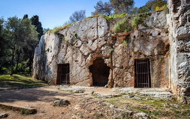 Ancient rock-cut caves in Athens, Greece, part of a self-guided city exploration game.