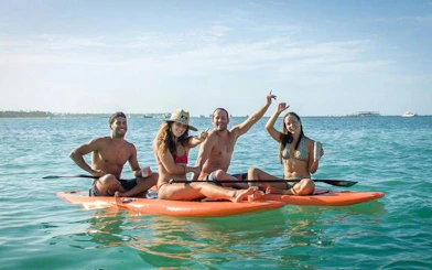 Group enjoying paddleboarding on Miches Snorkeling Cruise, Punta Cana.