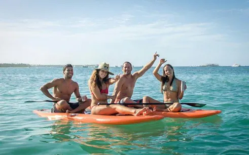 Group enjoying paddleboarding on Miches Snorkeling Cruise, Punta Cana.